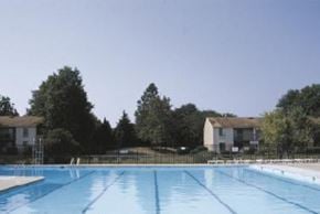 Virginia Beach apartment for rent - a large swimming pool in front of a house