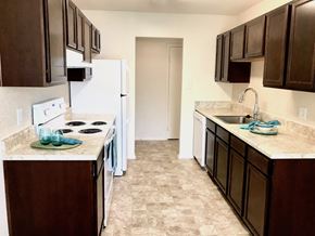 Chesapeake apartment for rent - a kitchen with brown cabinets and a white refrigerator