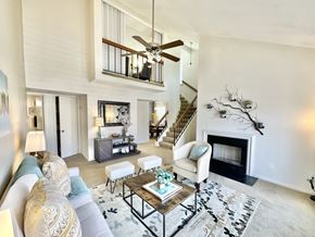 Virginia Beach apartment for rent - A living room with a staircase and a fireplace.