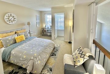 Virginia Beach apartment for rent - A bedroom with a large bed and a couch.
