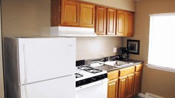 Ewing apartment for rent - a small kitchen with a stove and a refrigerator
