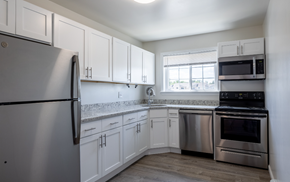 East Windsor apartment for rent - an empty kitchen with stainless steel appliances and white cabinets