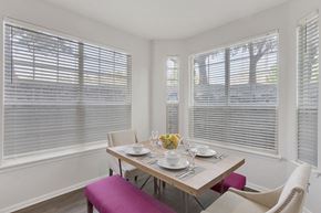 Greenwood Village apartment for rent - a dining room with three windows and a table with chairs