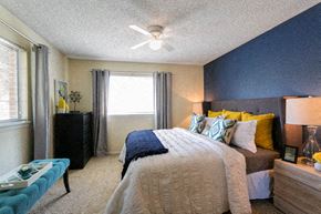 Littleton apartment for rent - a bedroom with a bed and a ceiling fan