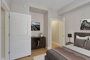 Denver apartment for rent - a bedroom with a large bed and a door to a closet