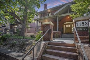 Denver apartment for rent - the front of a house with stairs and a sign in front of it