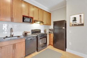 Denver apartment for rent - a kitchen with stainless steel appliances and wooden cabinets