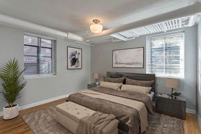 Denver apartment for rent - a bedroom with a bed and two windows