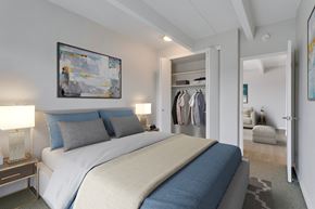 Denver apartment for rent - A bedroom with a large bed and a painting on the wall.