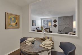 Denver apartment for rent - a dining room with a table and chairs next to a window