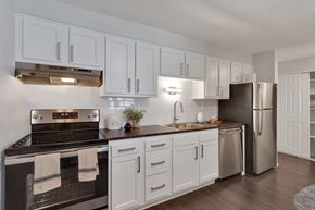 Denver apartment for rent - a kitchen with stainless steel appliances and white cabinets