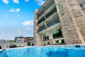 Denver apartment for rent - A swimming pool in front of a building with the number 1105 on it.