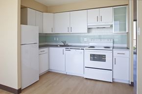 Denver apartment for rent - a white kitchen with white appliances and white cabinets