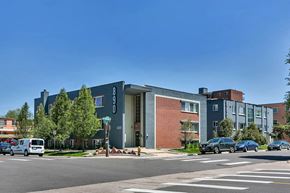 Denver apartment for rent - a building with cars parked in front of it on a street