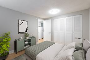Denver apartment for rent - A bedroom with a bed, nightstand, and a plant.