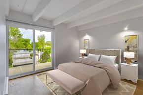 Denver apartment for rent - a bedroom with a bed and a sliding glass door