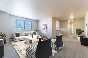 Denver apartment for rent - A living room with a sofa, armchairs, and a coffee table.
