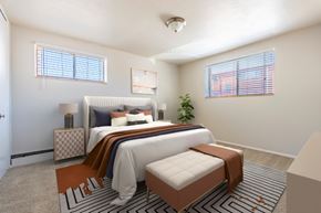Denver apartment for rent - A bedroom with a large bed and a small bed in it.