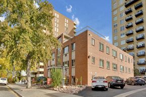 Denver apartment for rent - a brick building with cars parked in front of it