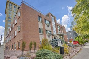 Denver apartment for rent - a large brick building with a sidewalk in front of it
