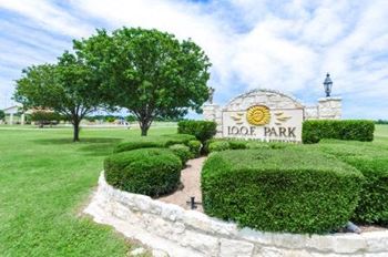 Community entrance sign with manicured landscaping