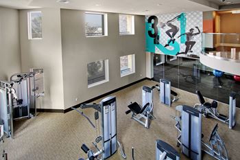 Health club quality fitness center with yoga studio, cardio/strength training equipment and free weights