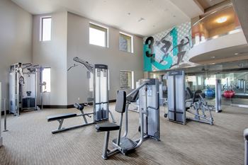 Health club quality fitness center with yoga studio, cardio/strength training equipment and free weights