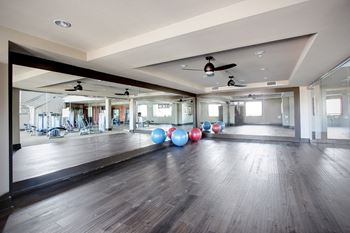 Health club quality fitness center with yoga studio, cardio/strength training equipment and free weights