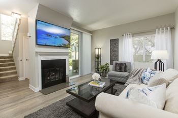 A living room with a fireplace and a tv above it