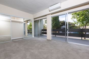 Living room with glass doors and a carpeted floor