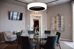 Gladstone townhouse for rent - a dining room with a glass table and chairs