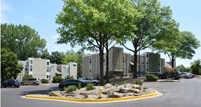 Gladstone apartment for rent - an apartment complex with cars parked in a parking lot