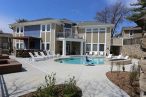 Gladstone apartment for rent - a large swimming pool in front of a house