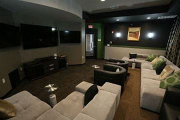Gladstone apartment for rent - a living room with couches and chairs and a television