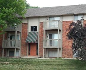 Liberty apartment for rent - a brick apartment building with balconies and a yard