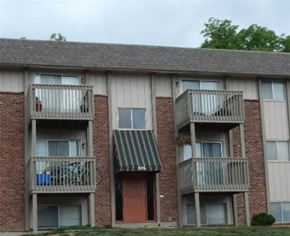 Liberty apartment for rent - an apartment building with balconies and a green and white roof