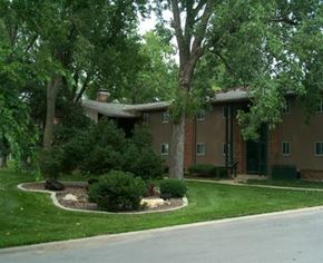 Overland Park apartment for rent - a house with a yard and trees in front of it