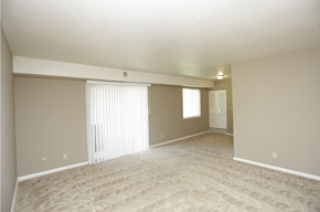 Liberty apartment for rent - the spacious living room and dining room of an empty home with a large sliding door