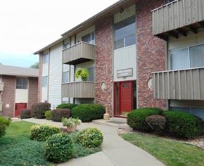 Liberty apartment for rent - an apartment building with a red door and a sidewalk