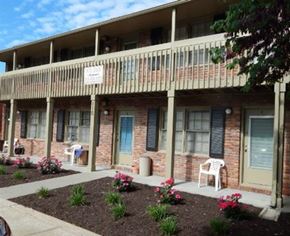 Liberty apartment for rent - a building with a porch and a sign on the balcony