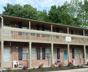Liberty apartment for rent - a brick building with a porch and a balcony