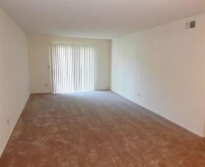 Liberty apartment for rent - an empty living room with a white wall and a window