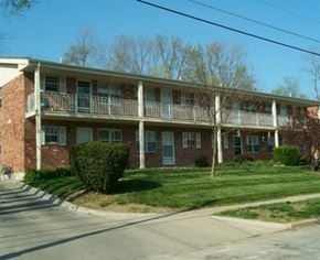 Liberty apartment for rent - a brick apartment building with a porch and a lawn