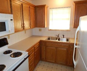 Liberty apartment for rent - a kitchen with a stove microwave and a sink