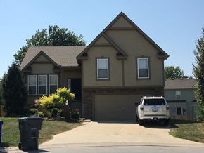 Shawnee apartment for rent - a house with a van parked in front of it