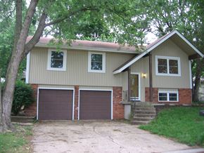 Shawnee apartment for rent - the front of a house with two garage doors