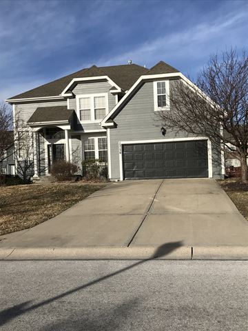 Shawnee apartment for rent - a house with a driveway and a garage door
