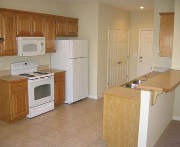 Shawnee apartment for rent - an empty kitchen with a stove and a refrigerator