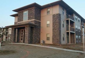 Watford City apartment for rent - a building with a brick facade and a sidewalk