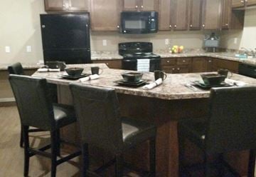 Watford City apartment for rent - a kitchen with a large island with chairs